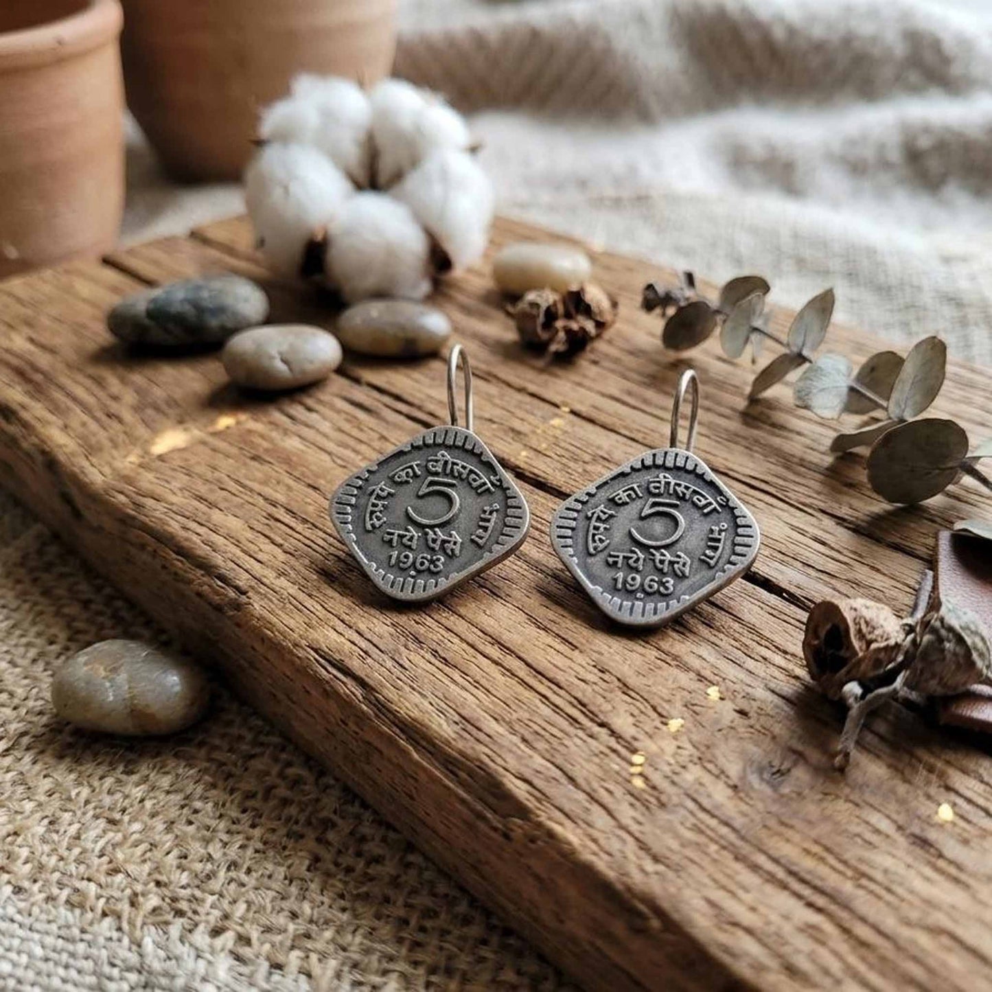 Vintage German Silver coin earrings on rustic wooden styling