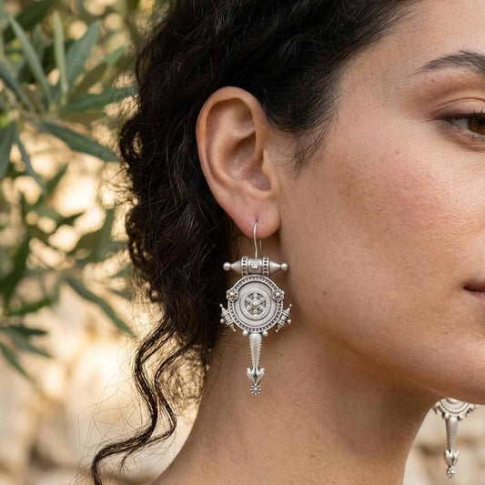 Antique tribal wheel hook earrings worn on ear