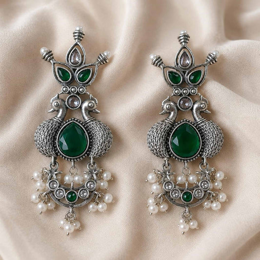 Traditional emerald peacock earrings flatlay