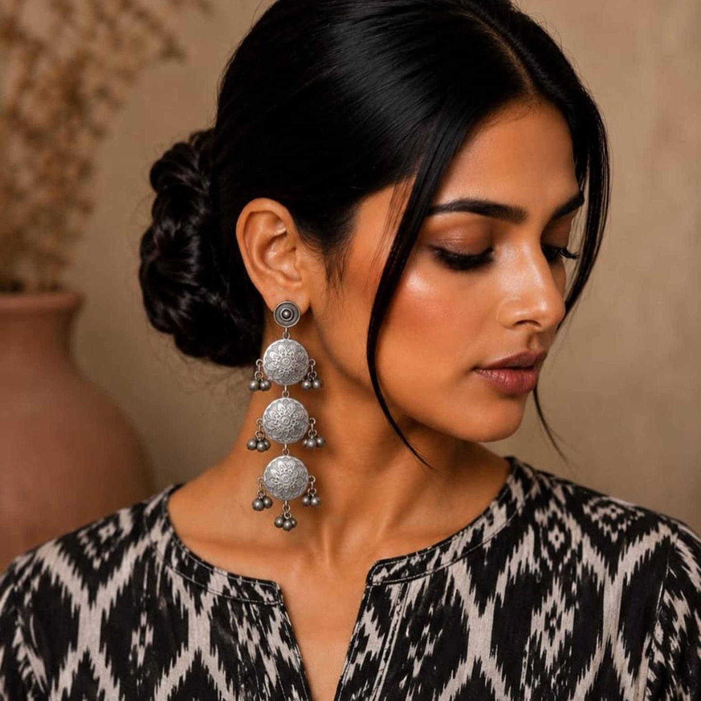 Model wearing long mandala ghunghroo german silver earrings