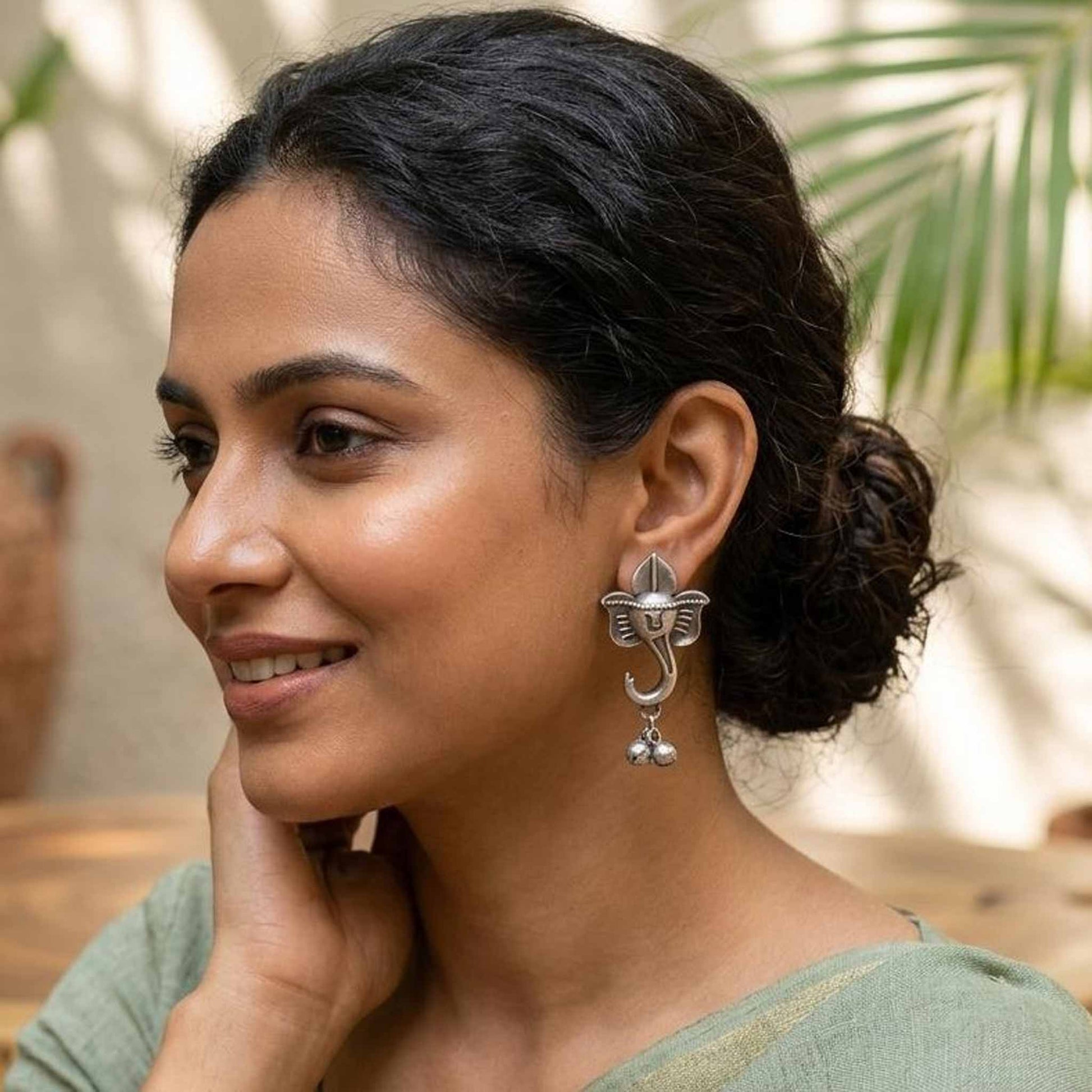 Woman wearing Ganesha German silver statement earrings