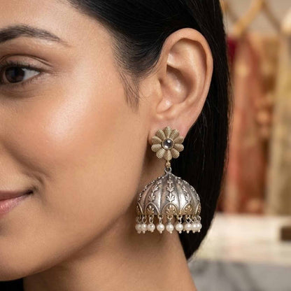 Model wearing dual tone pearl jhumka earrings