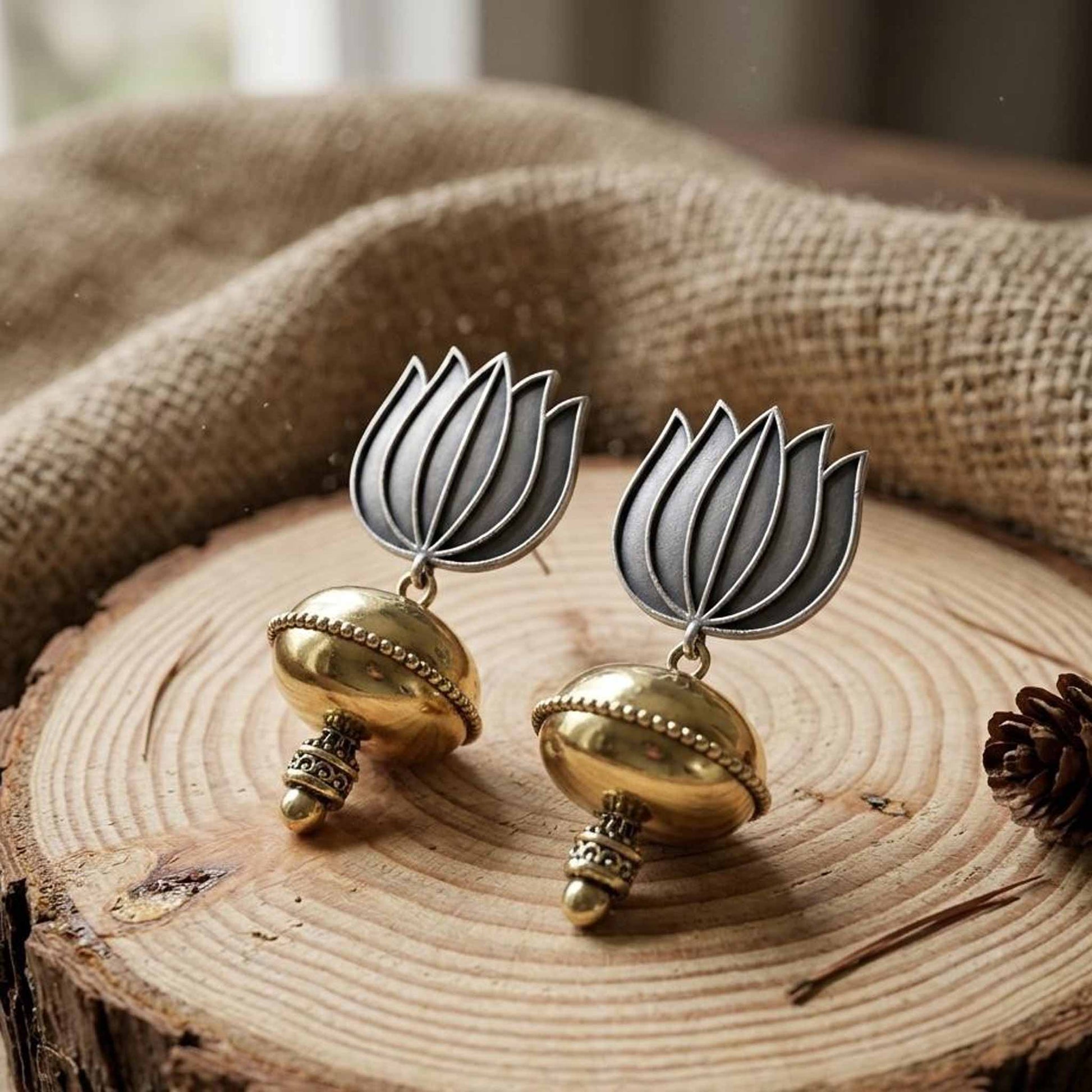 Handcrafted lotus dome jhumka earrings on wooden surface