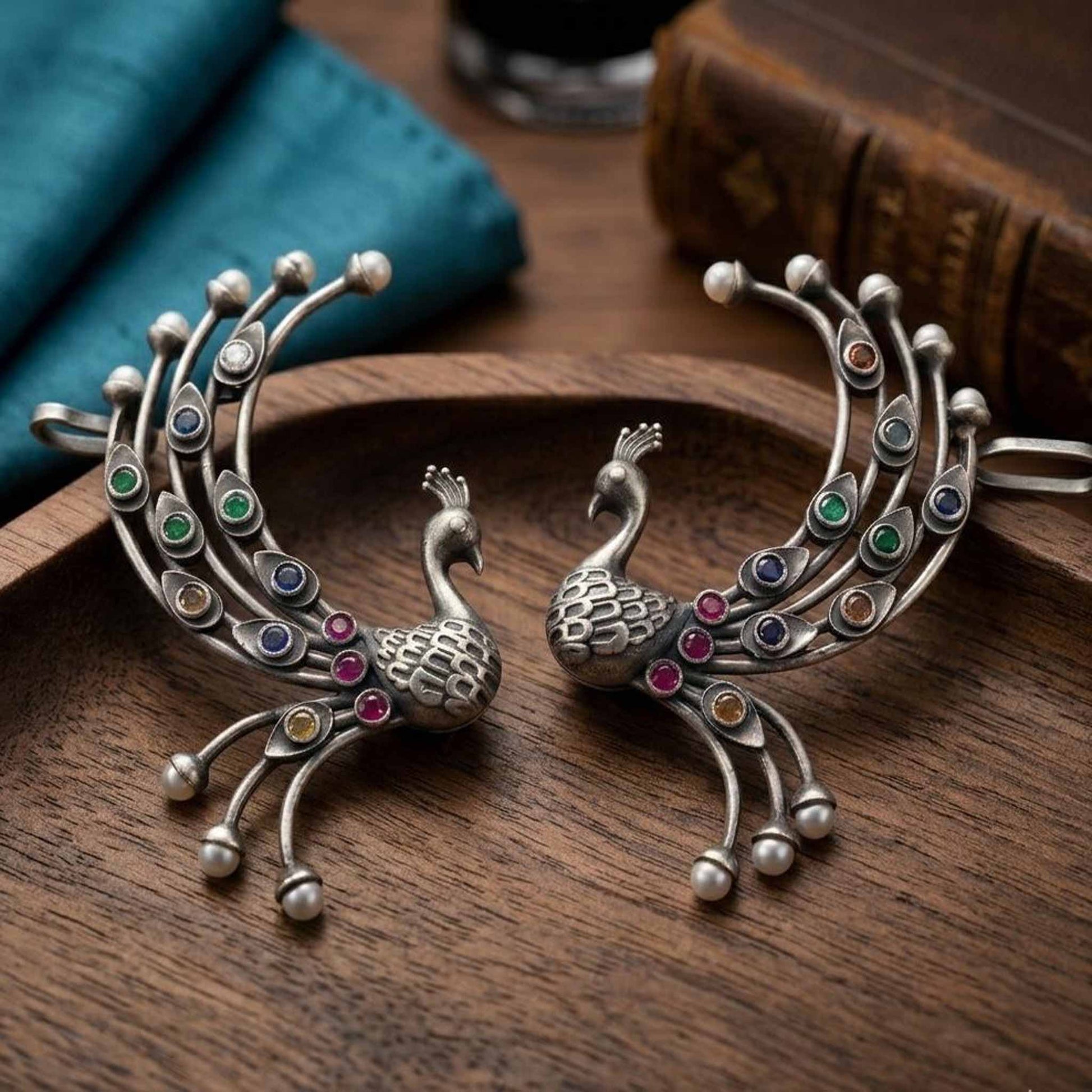 Statement German Silver peacock earrings on wooden bowl