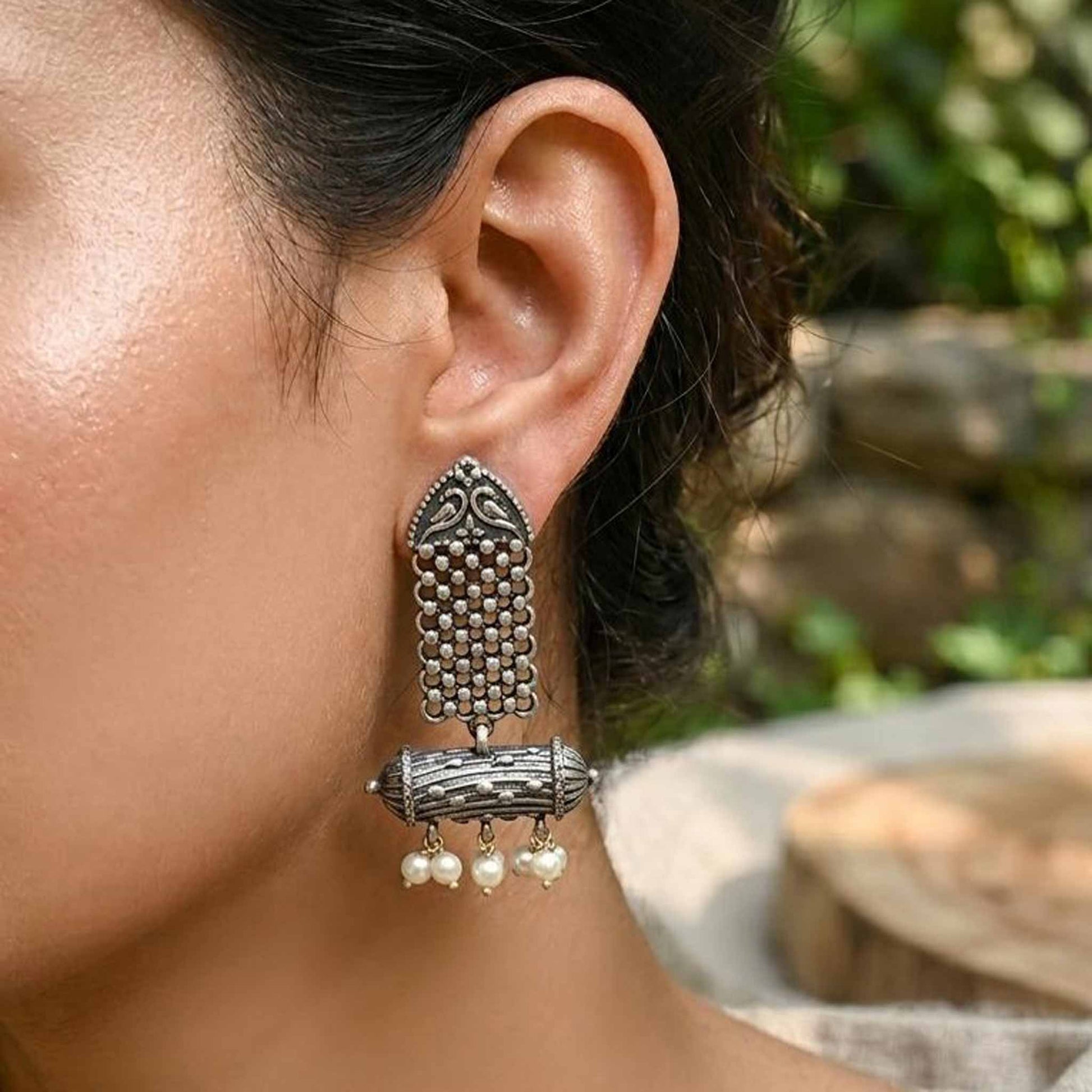 Side profile of heritage pearl dangler earrings on model