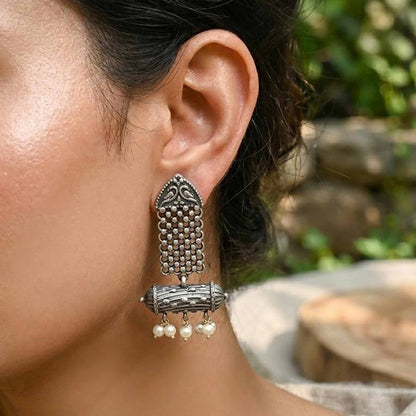 Side profile of heritage pearl dangler earrings on model