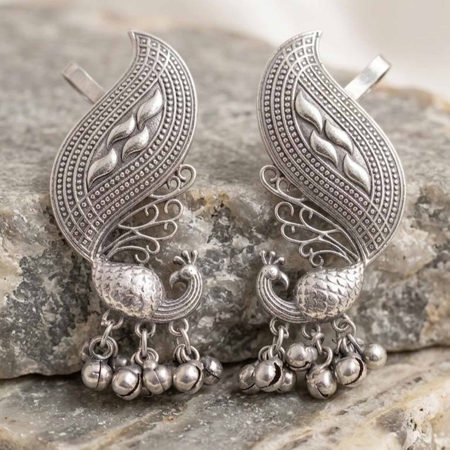 German Silver peacock ghunghroo earrings on stone