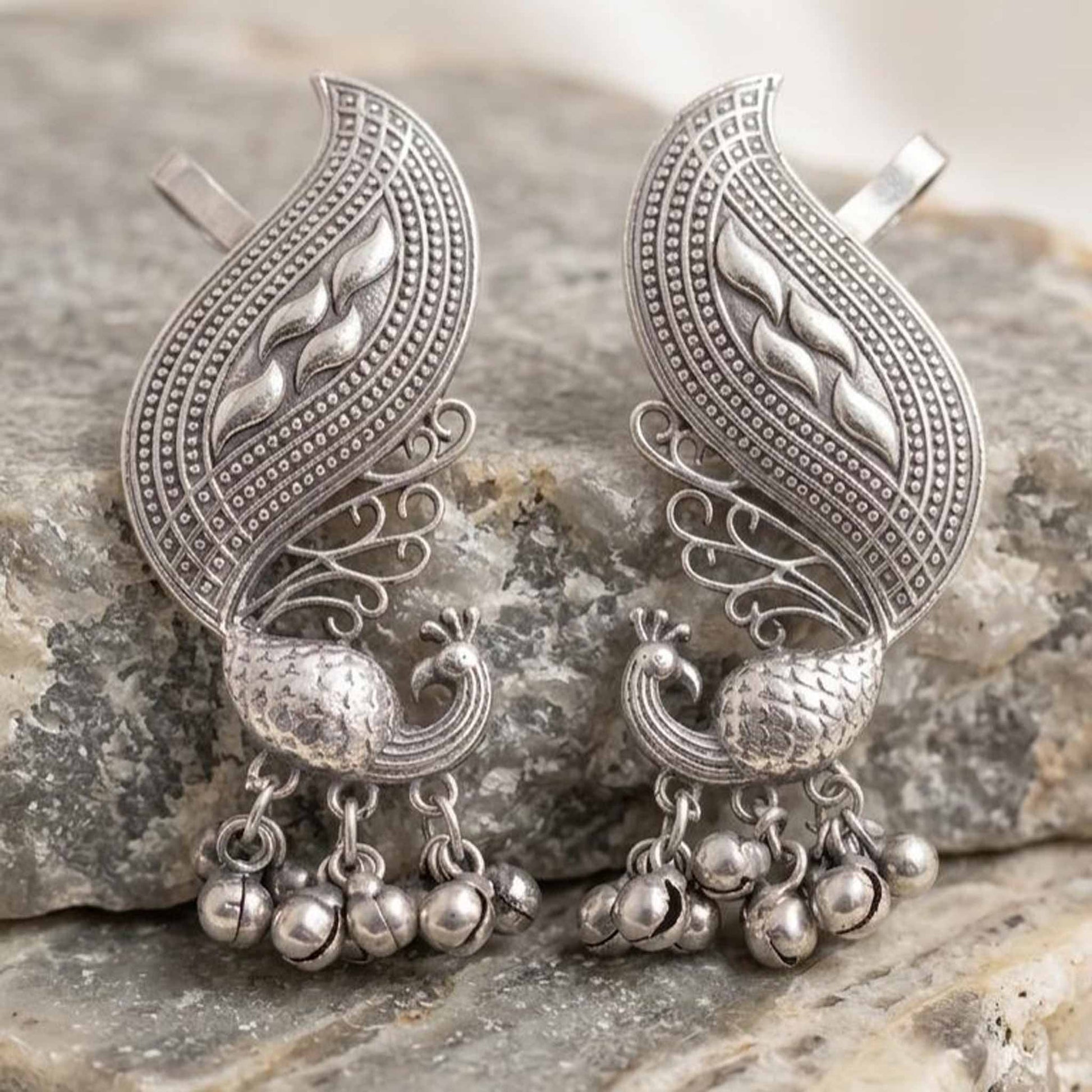 German Silver peacock ghunghroo earrings on stone