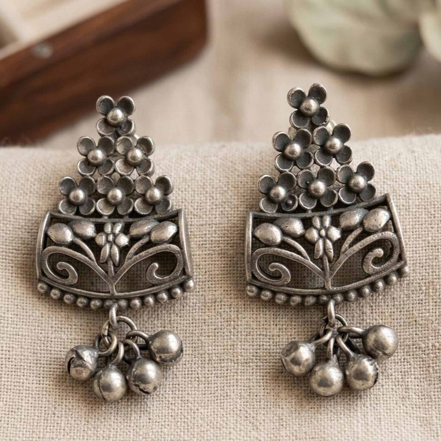 Closeup of handcrafted floral German silver earrings