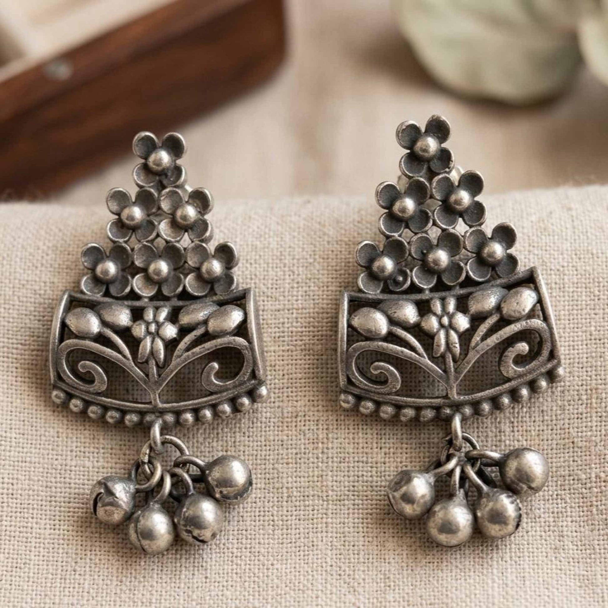 Closeup of handcrafted floral German silver earrings