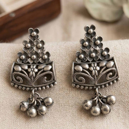 Closeup of handcrafted floral German silver earrings