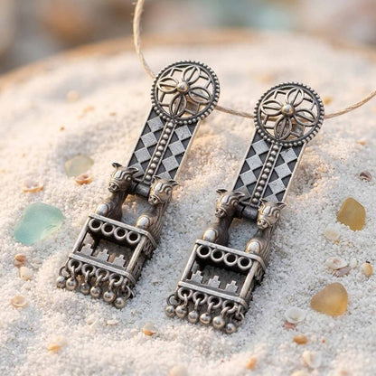 Traditional horse jharokha German Silver earrings displayed on sand