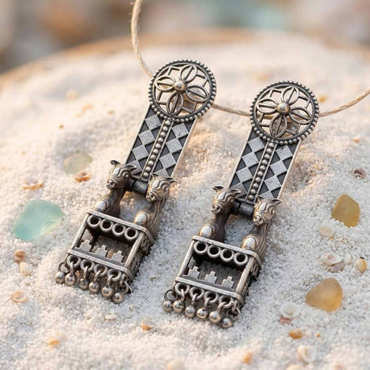 Traditional horse jharokha German Silver earrings displayed on sand