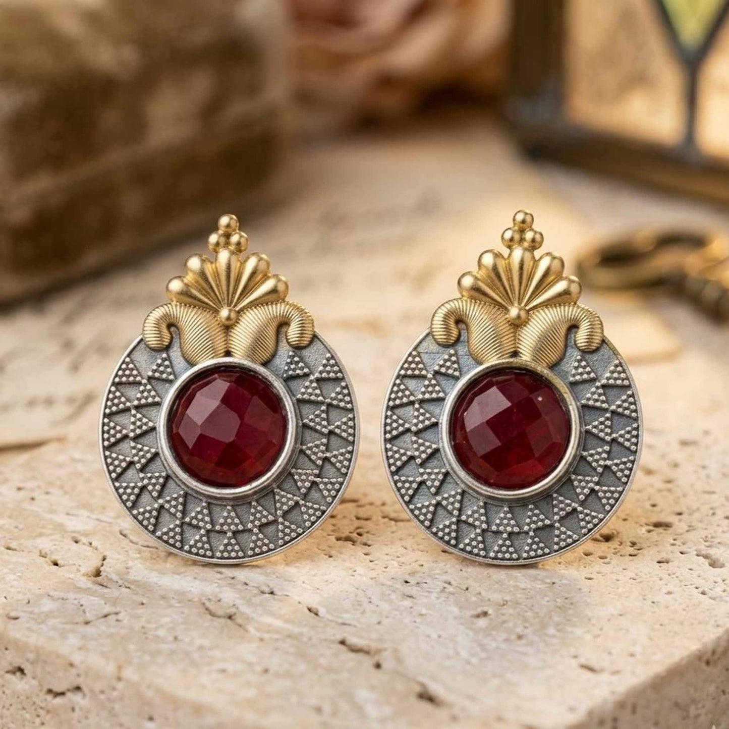 Elegant ruby ethnic earrings on stone surface