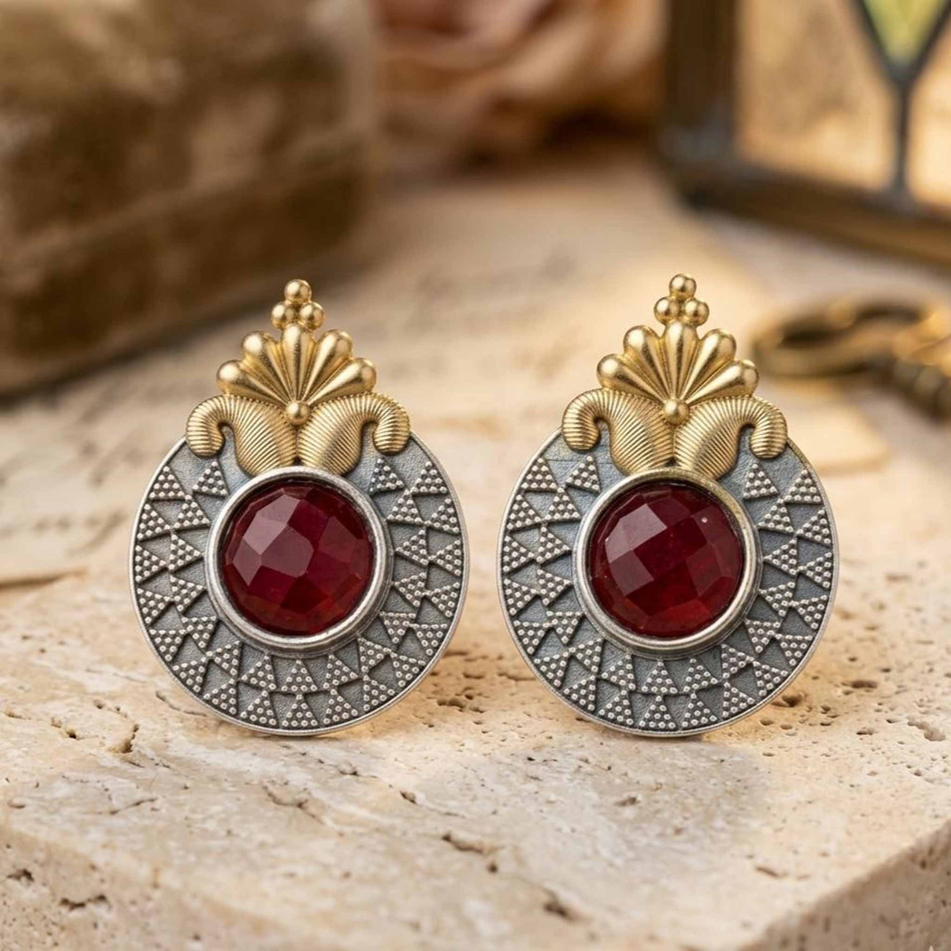 Elegant ruby ethnic earrings on stone surface