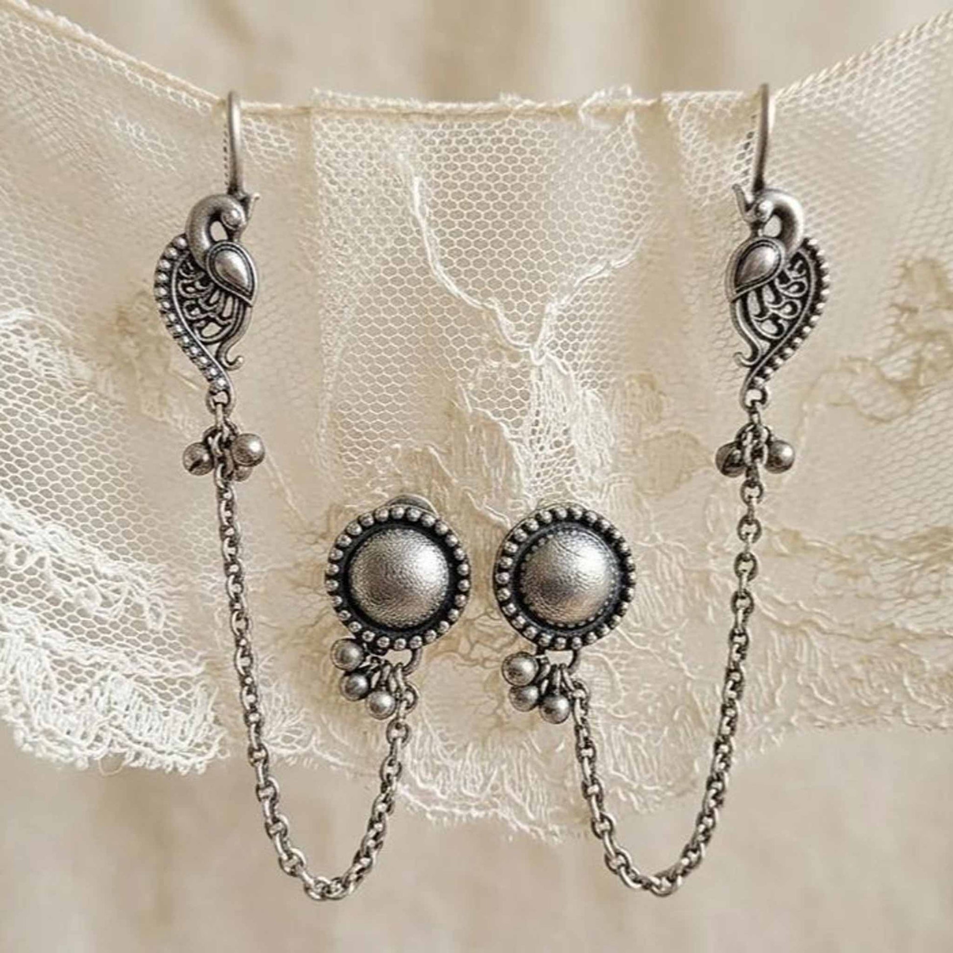 Closeup of German Silver peacock ear chain earrings