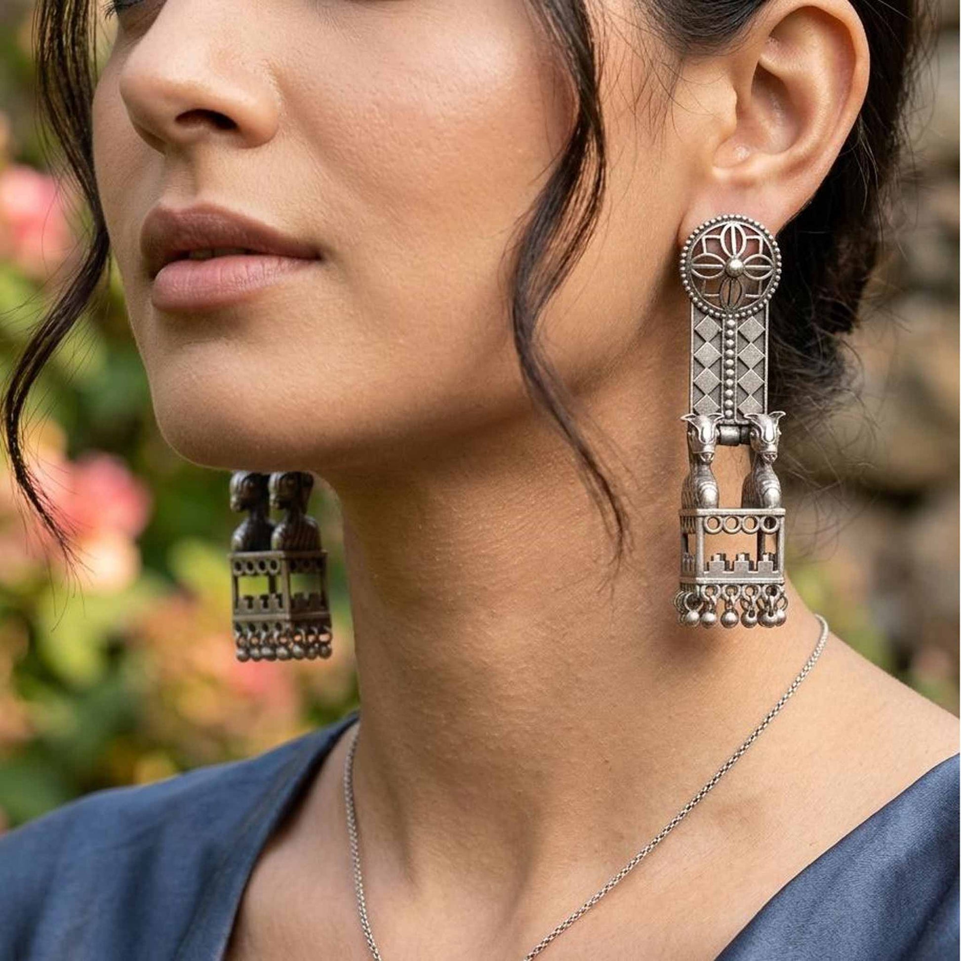 Close-up German Silver horse jharokha earrings worn by model