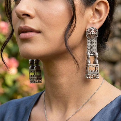 Close-up German Silver horse jharokha earrings worn by model