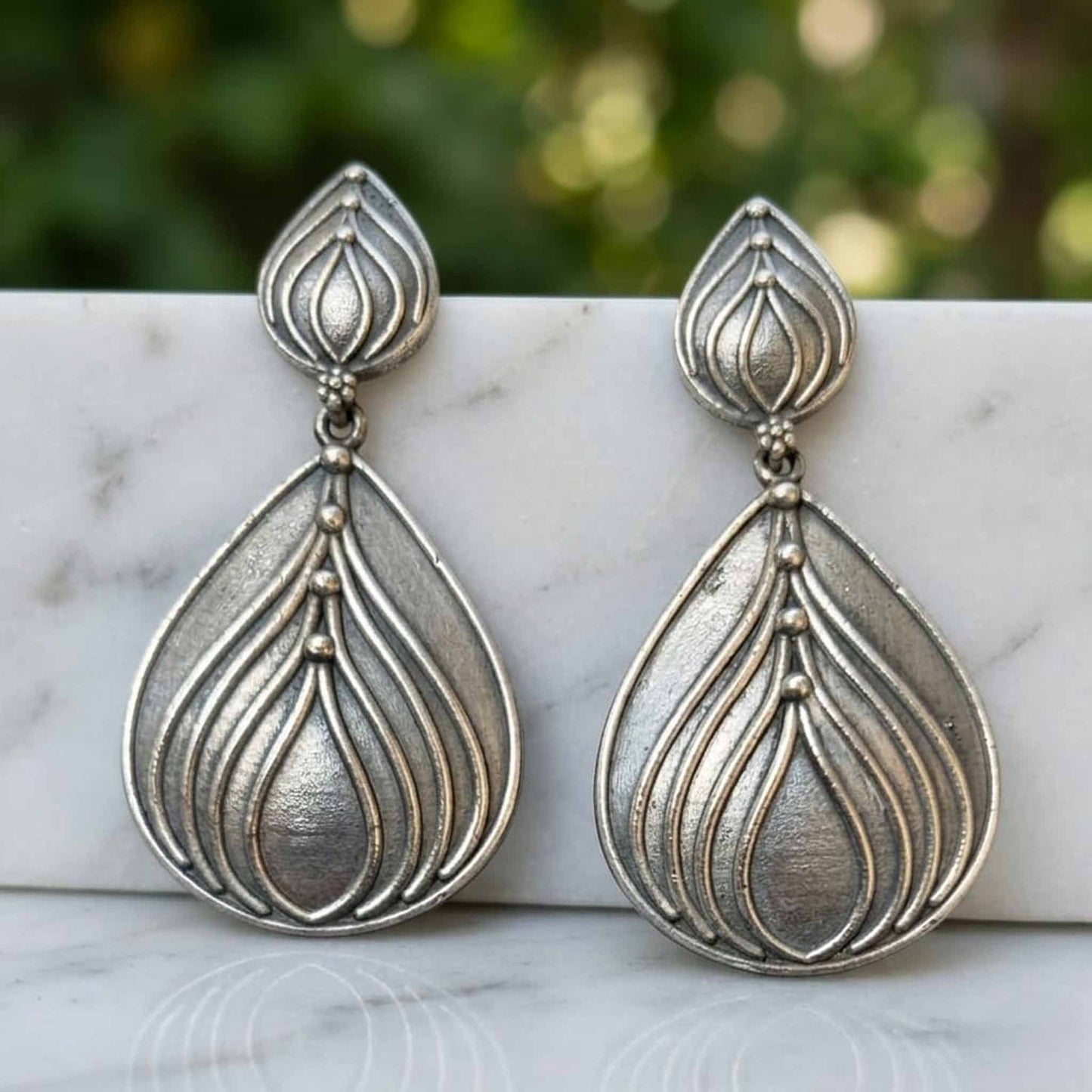 Minimal lotus drop German silver earrings display