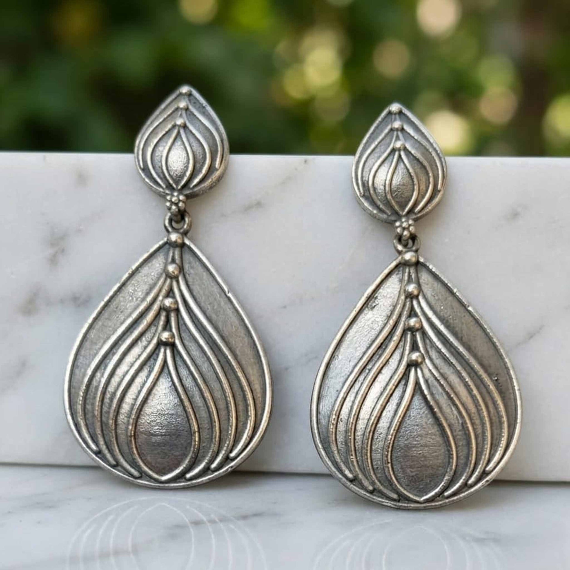 Minimal lotus drop German silver earrings display