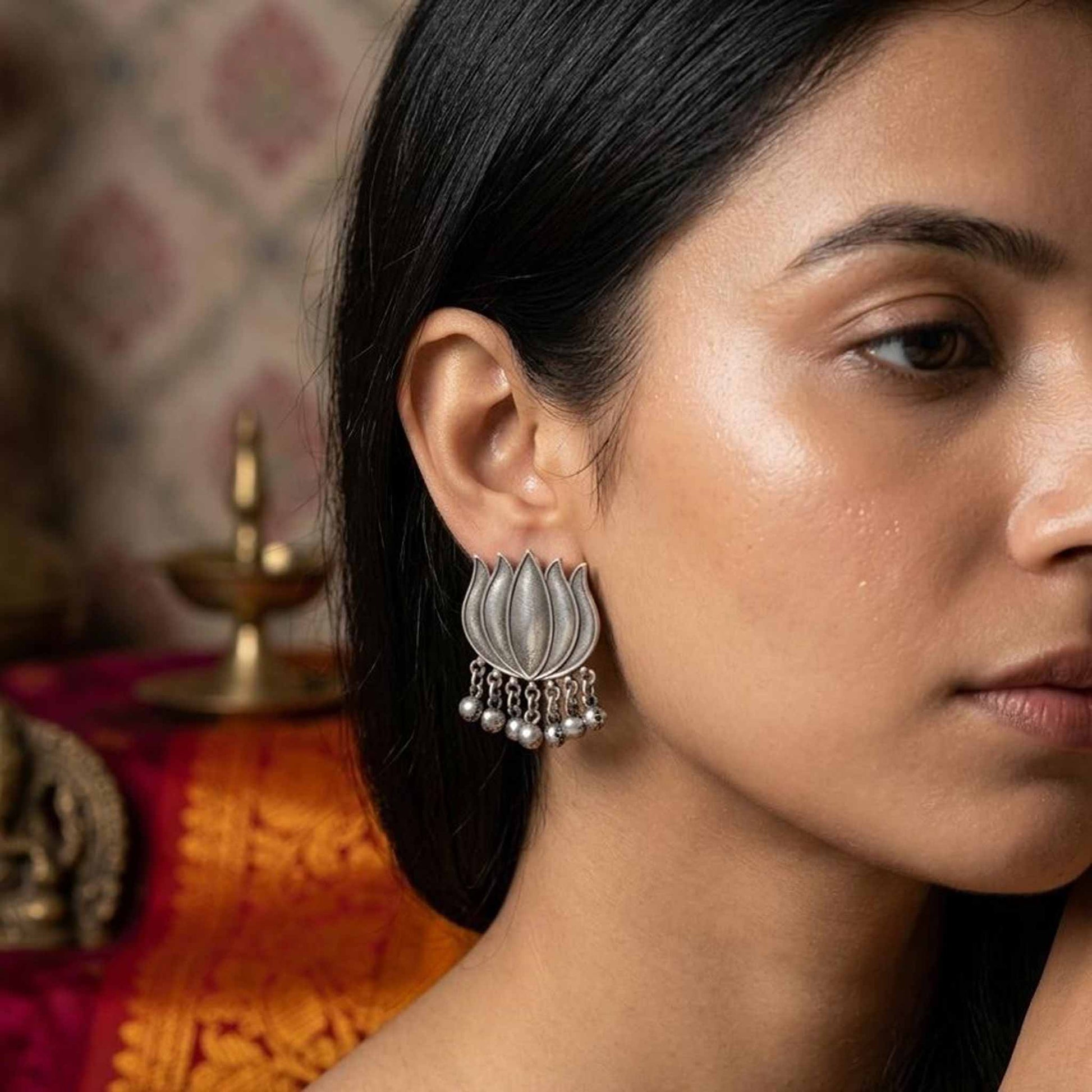 Lotus ghunghru stud earrings worn by model