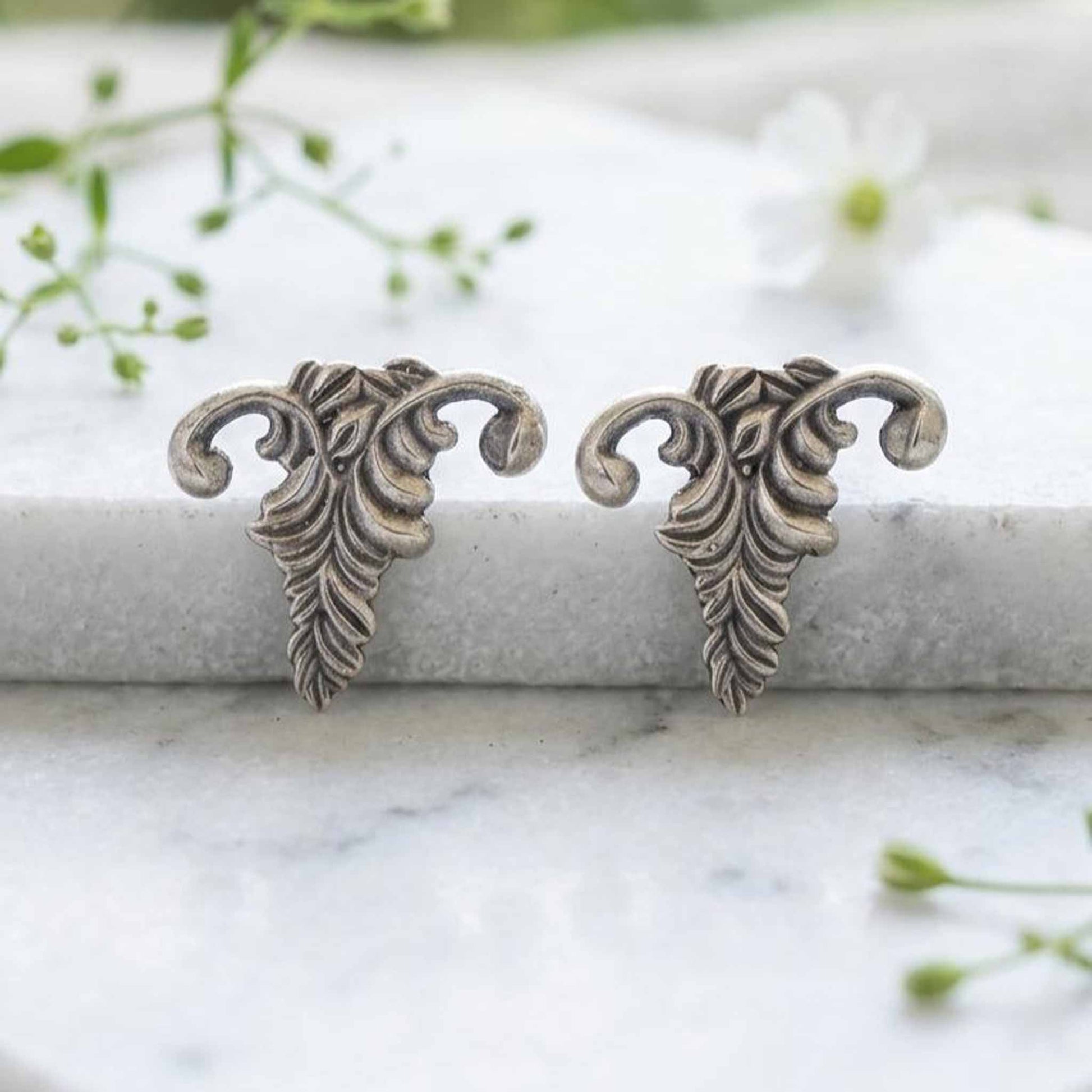 Botanical antique silver stud earrings closeup
