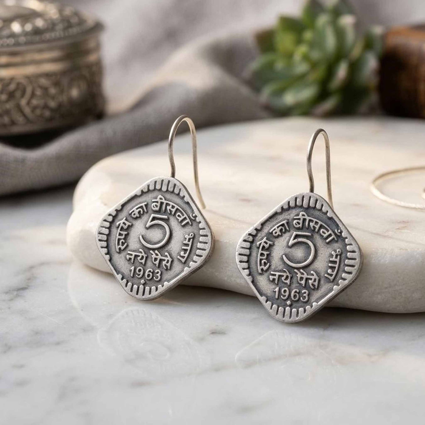 German Silver vintage coin earrings on marble backdrop