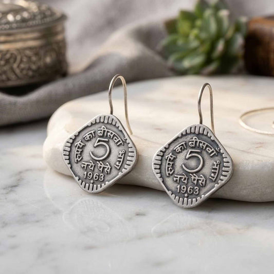German Silver vintage coin earrings on marble backdrop