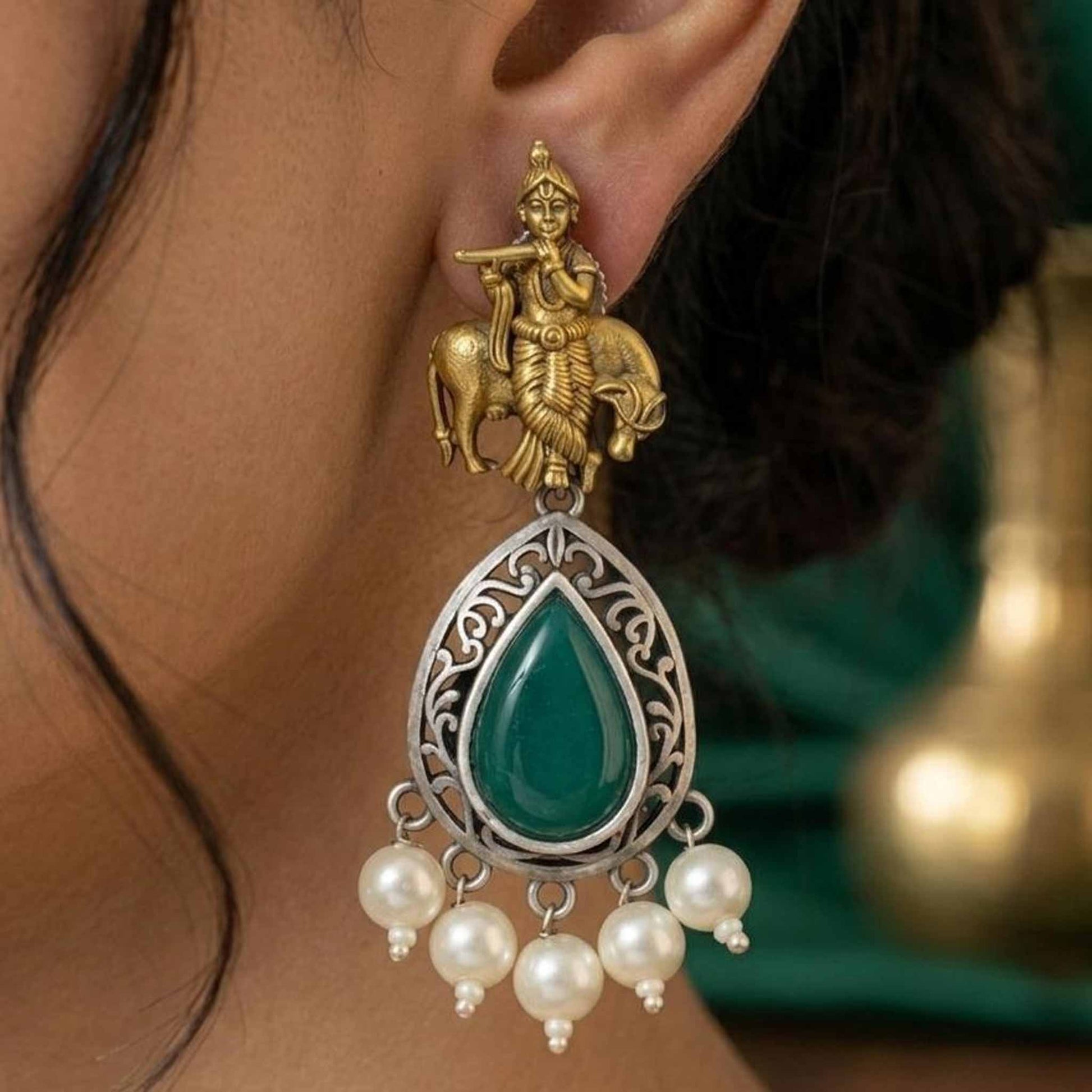 Closeup model shot of Krishna emerald pearl drop earrings