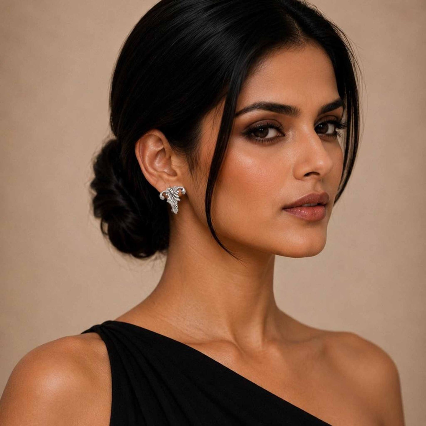 Model wearing abstract vine leaf earrings