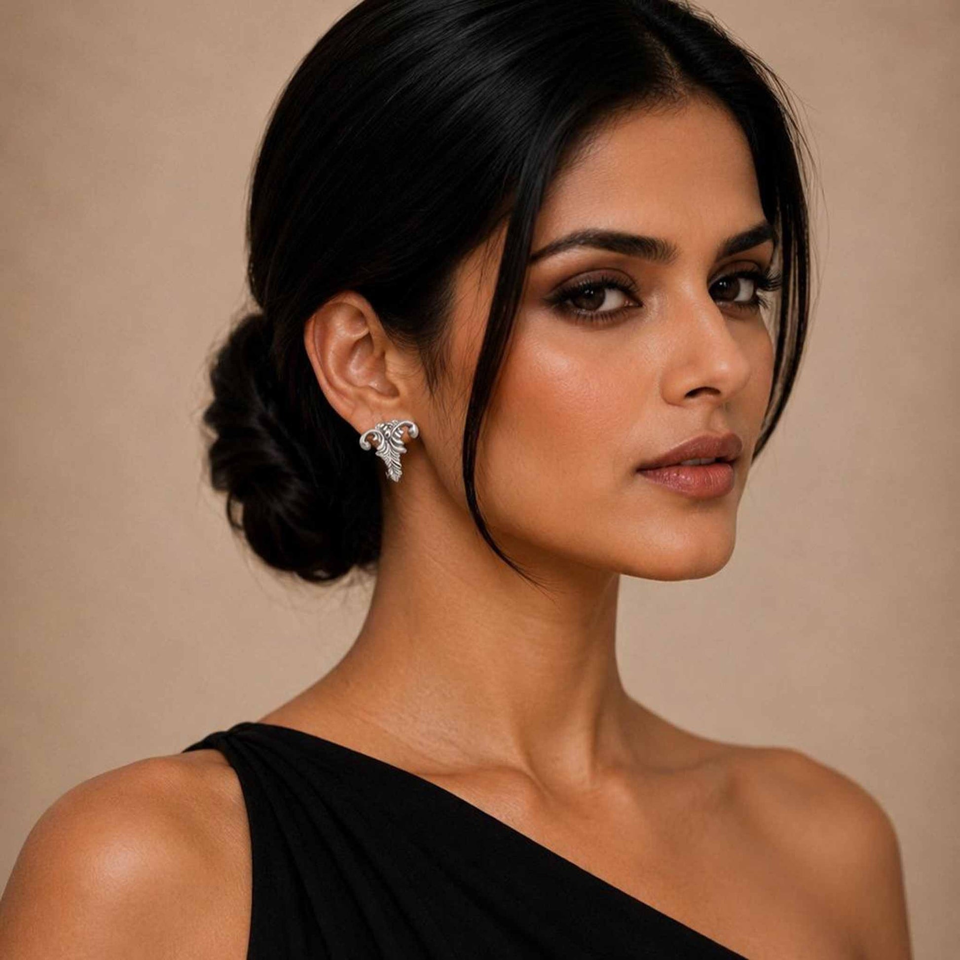 Model wearing abstract vine leaf earrings