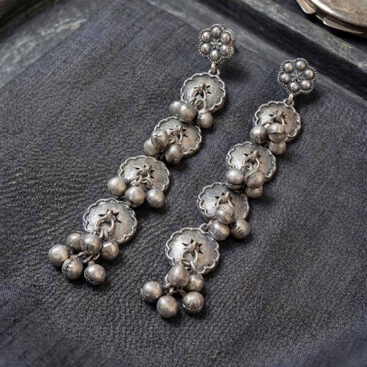 Ghughri Disc Drop Earrings flatlay black fabric view