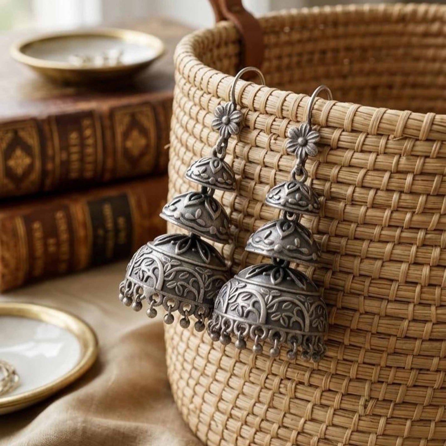 Styled basket shot of long three dome jhumka earrings