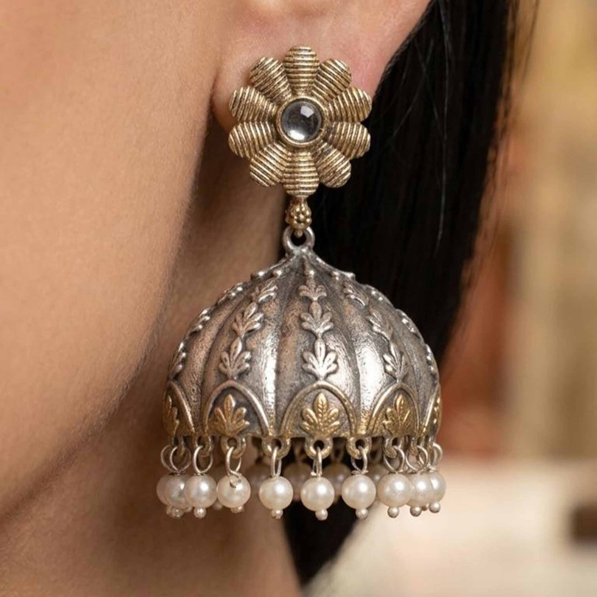Dual tone embossed pearl jhumka earrings on model