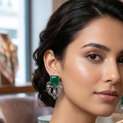 Model wearing emerald green statement earrings