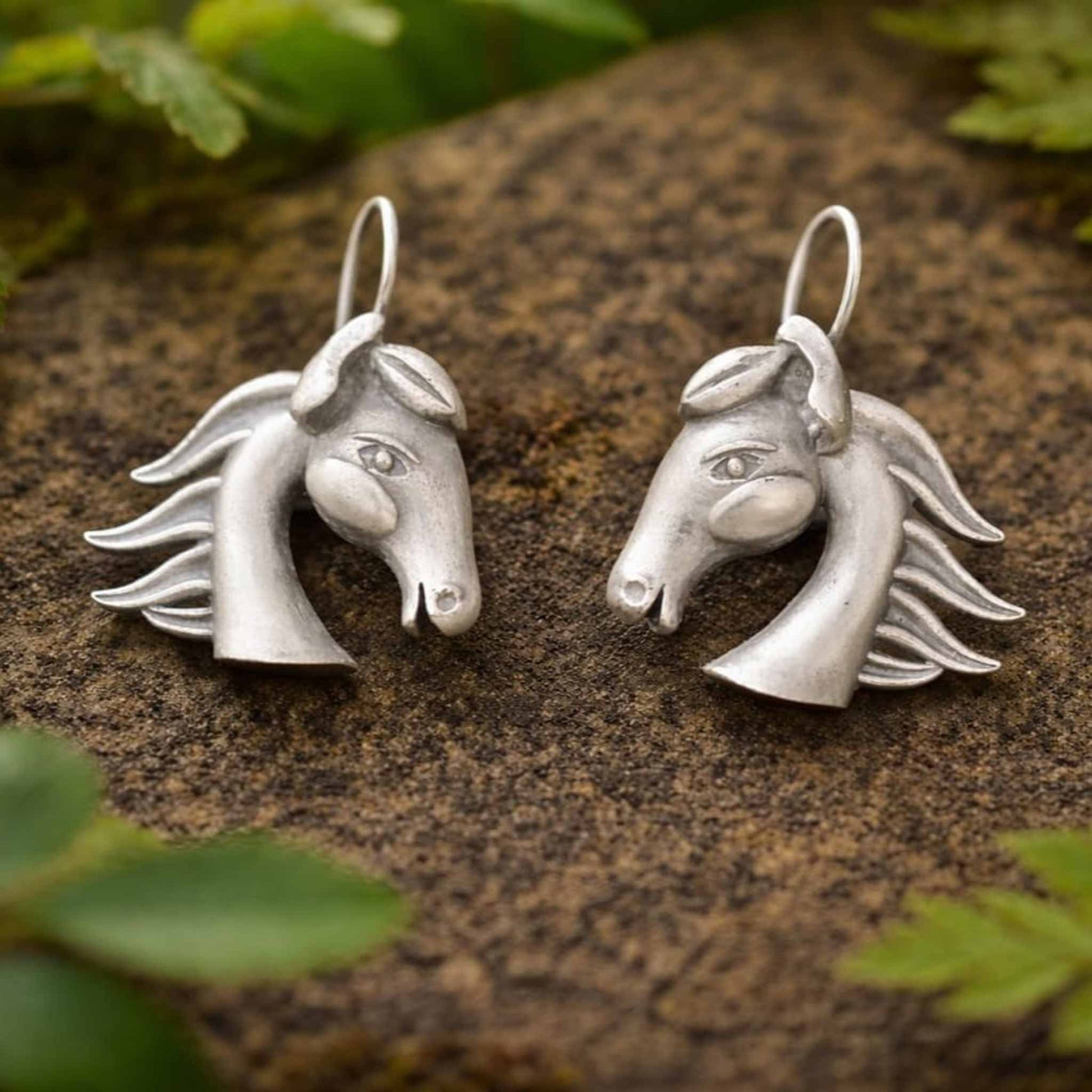 Handcrafted horse head earrings outdoor styling display