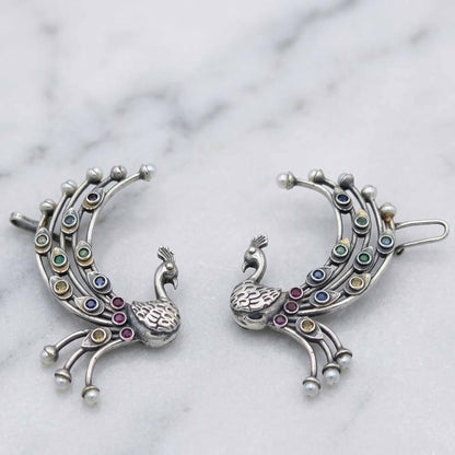 German Silver peacock ear cuff earrings on marble surface
