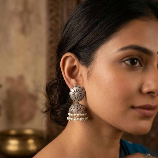 Woman wearing petal pearl jhumka earrings