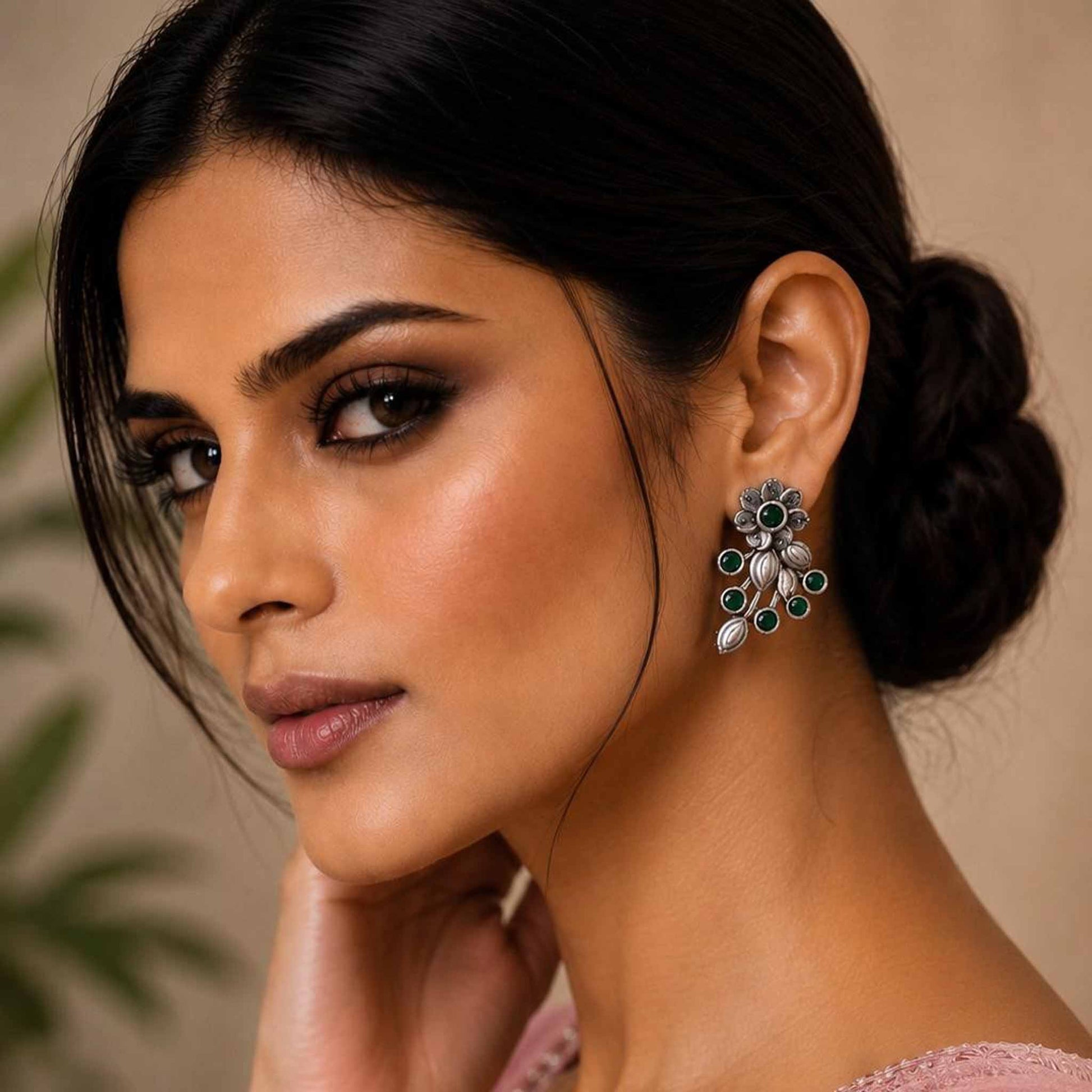 Model wearing green floral vine stud earrings
