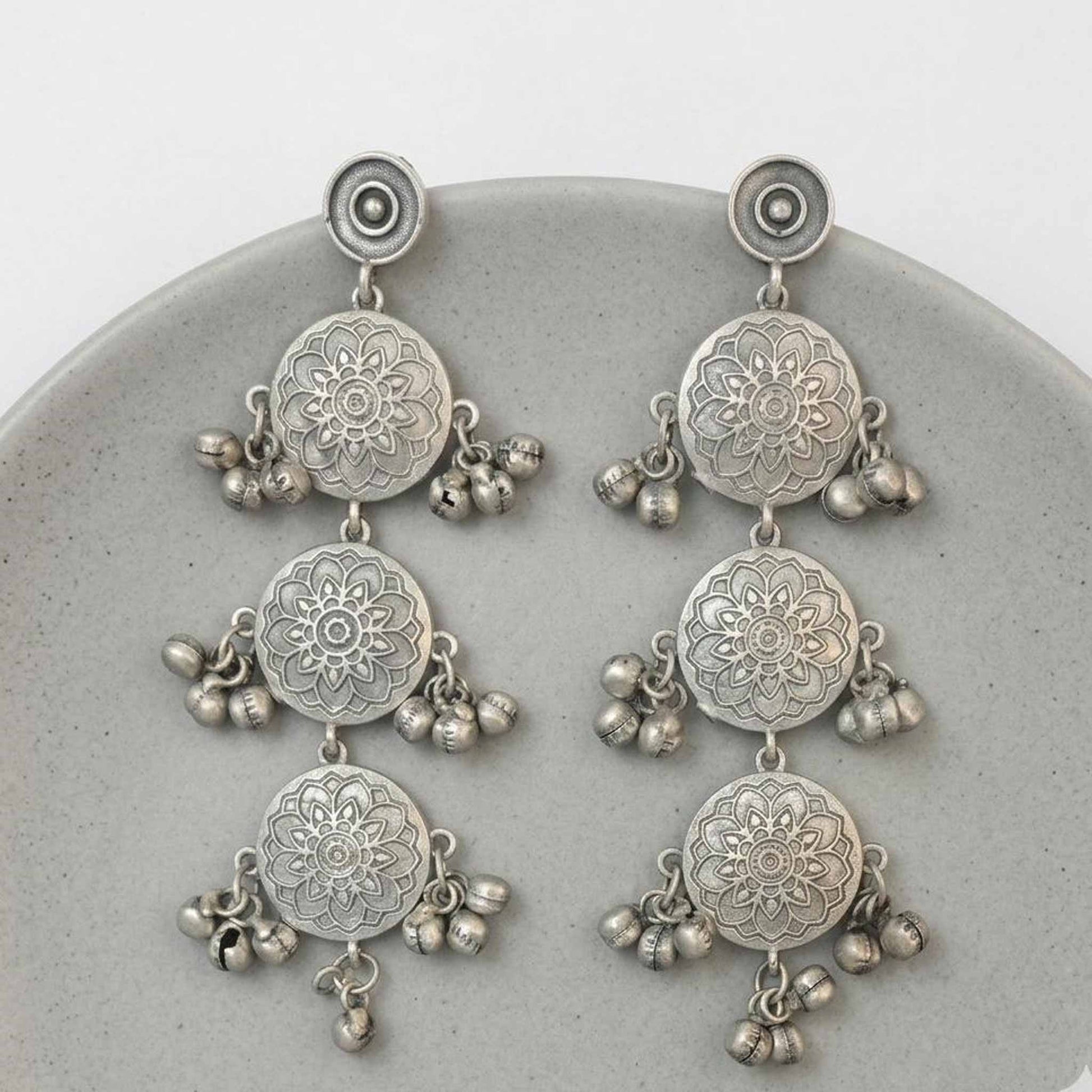 Minimal flatlay of german silver mandala dangler earrings