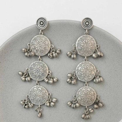 Minimal flatlay of german silver mandala dangler earrings