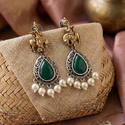 Styled ethnic display of Krishna emerald earrings