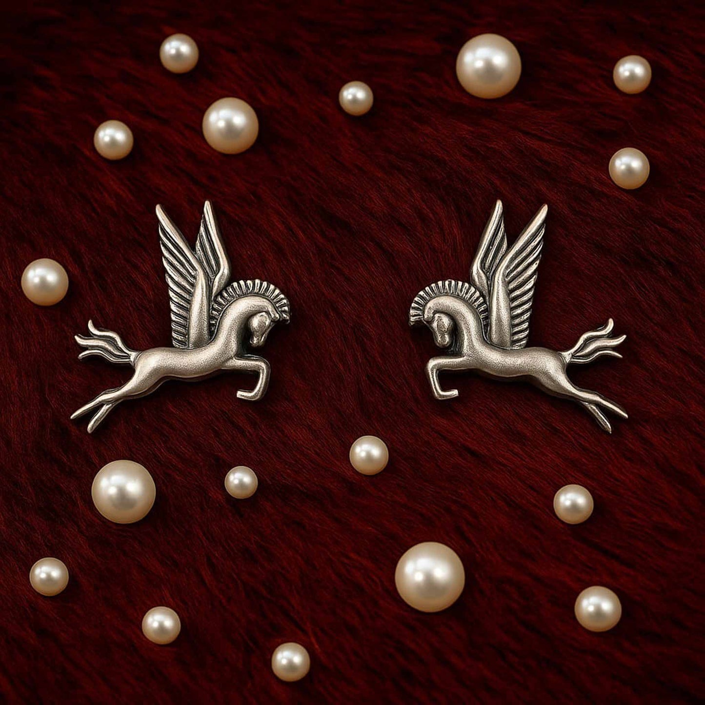 Pegasus earrings flatlay with pearl decorative styling