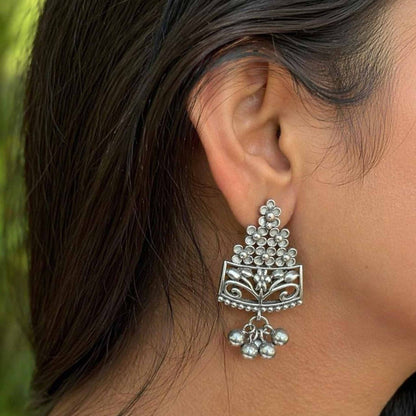 Side profile styling view of floral German silver earrings