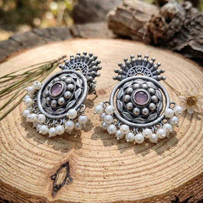 Pearl German Silver floral earrings displayed on wooden surface