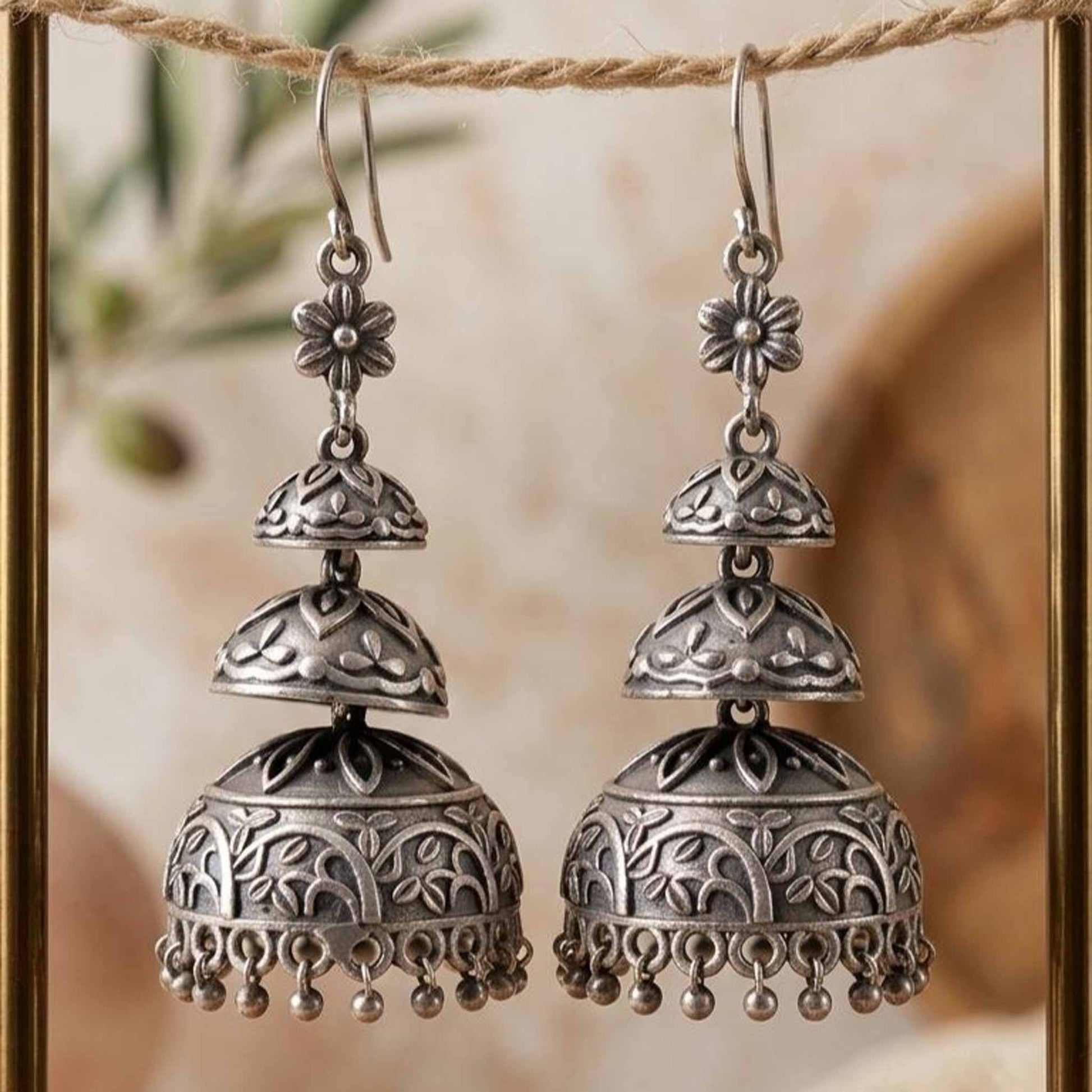 Front closeup of layered dome jhumka earrings