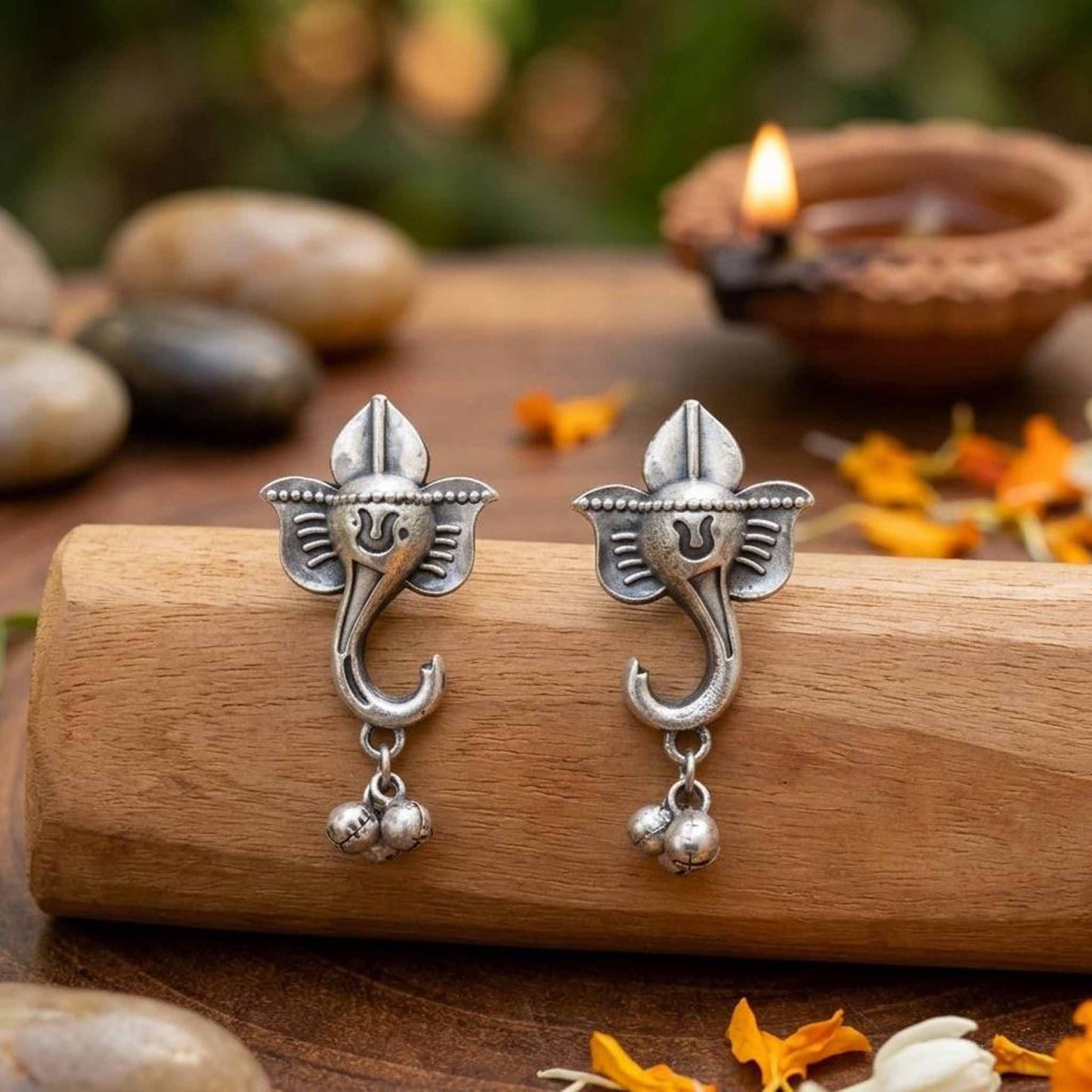 Festive Ganesha ghungroo earrings wooden styling display