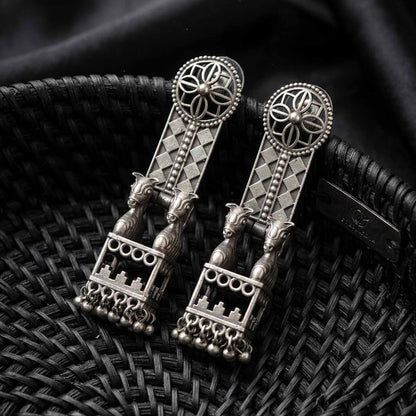 Horse jharokha German Silver statement earrings on black woven background
