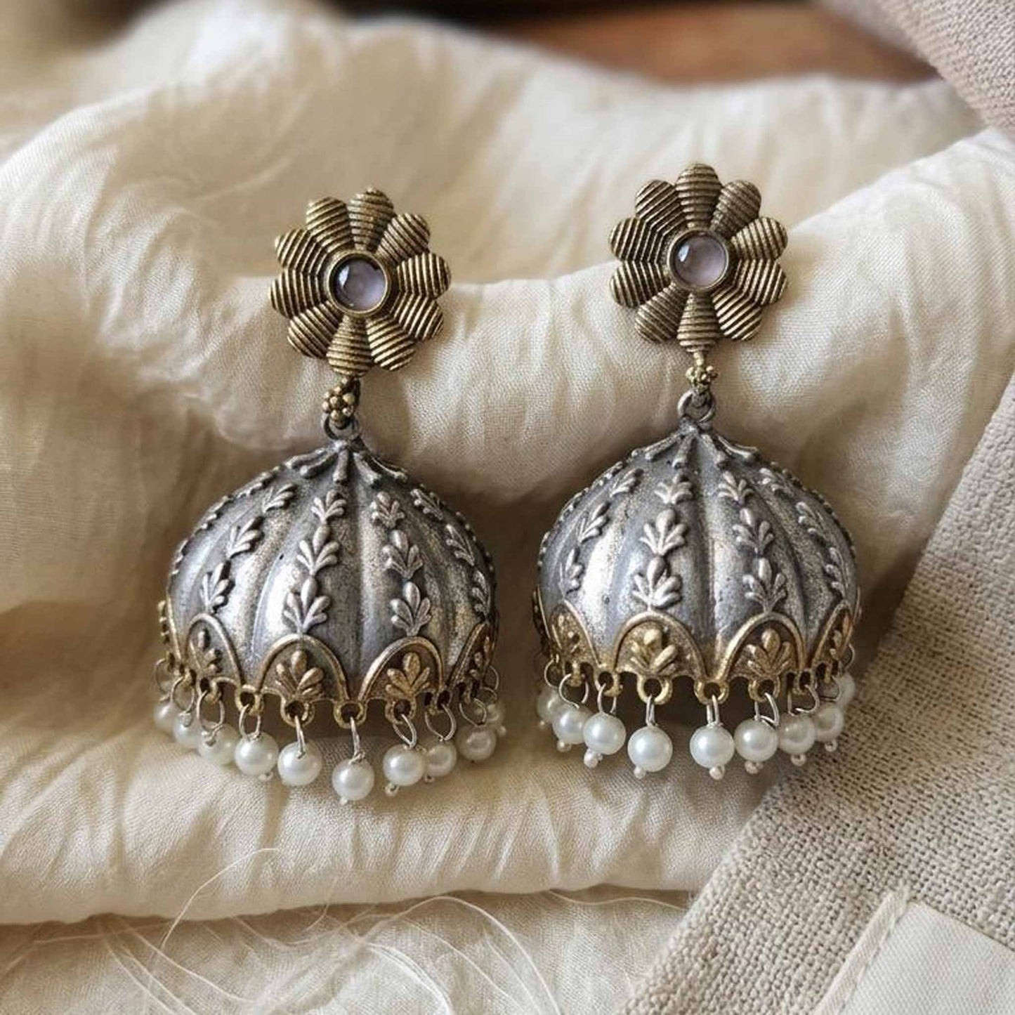 Dual tone embossed jhumka earrings closeup