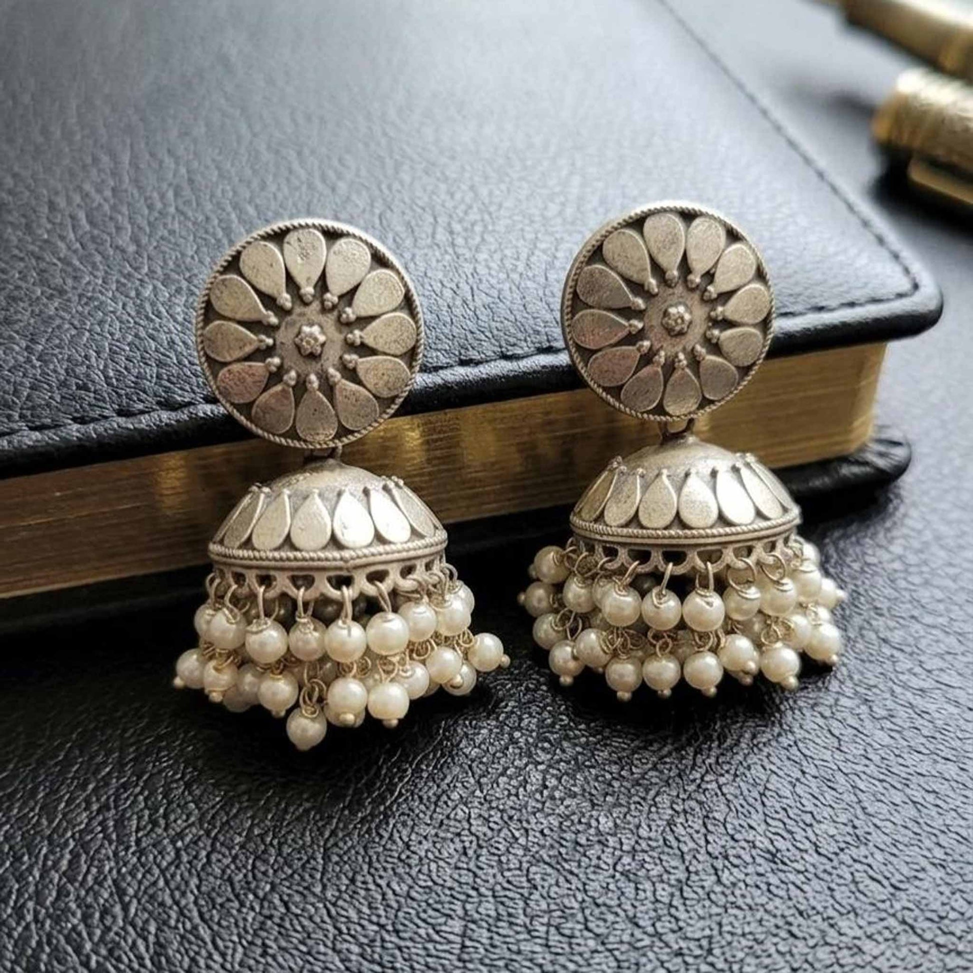 Closeup of German Silver silver pearl jhumka earrings